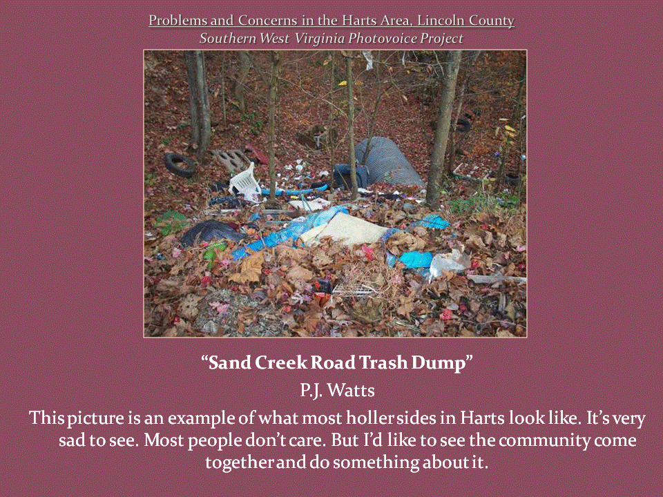Discarded tires, plastic containers, broken furniture, and household garbage scattered across a leaf-covered wooded hillside.