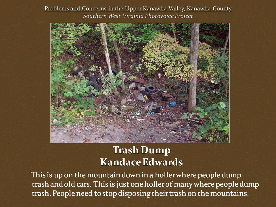 Discarded tires, metal scraps, and other garbage scattered among trees and underbrush on a wooded mountainside.