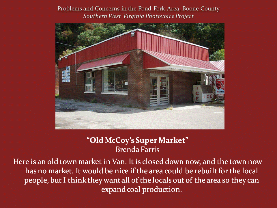 A closed brick supermarket with a red metal roof and awnings stands beside an empty parking area in Van.